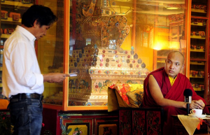 Nyima Thondup (co-organizer of Tibet Film Festival) presenting the program of  Tibet Film Festival to H.H. the Gyalwa Karmapa, ©Filming for Tibet/David Huang