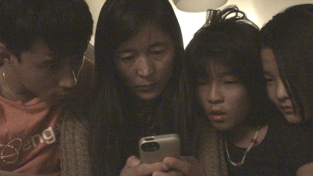 Wife and children speaking to Dhondup Wangchen at the day of his release, 5 June 2014 family_speakting_to_Dhondup