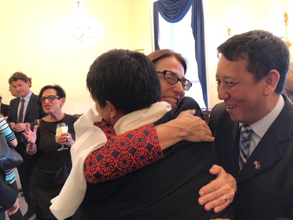 Sarah Sewall hugging Dhondup Wangchen, right Jamyang Tsultrim